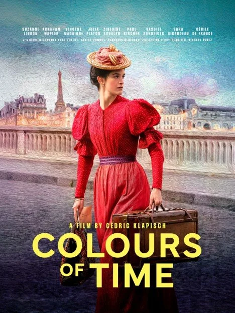 A poster for the film 'Colours of Time' featuring a woman in a red dress and hat standing by the Seine River in Paris with the Eiffel Tower in the background.