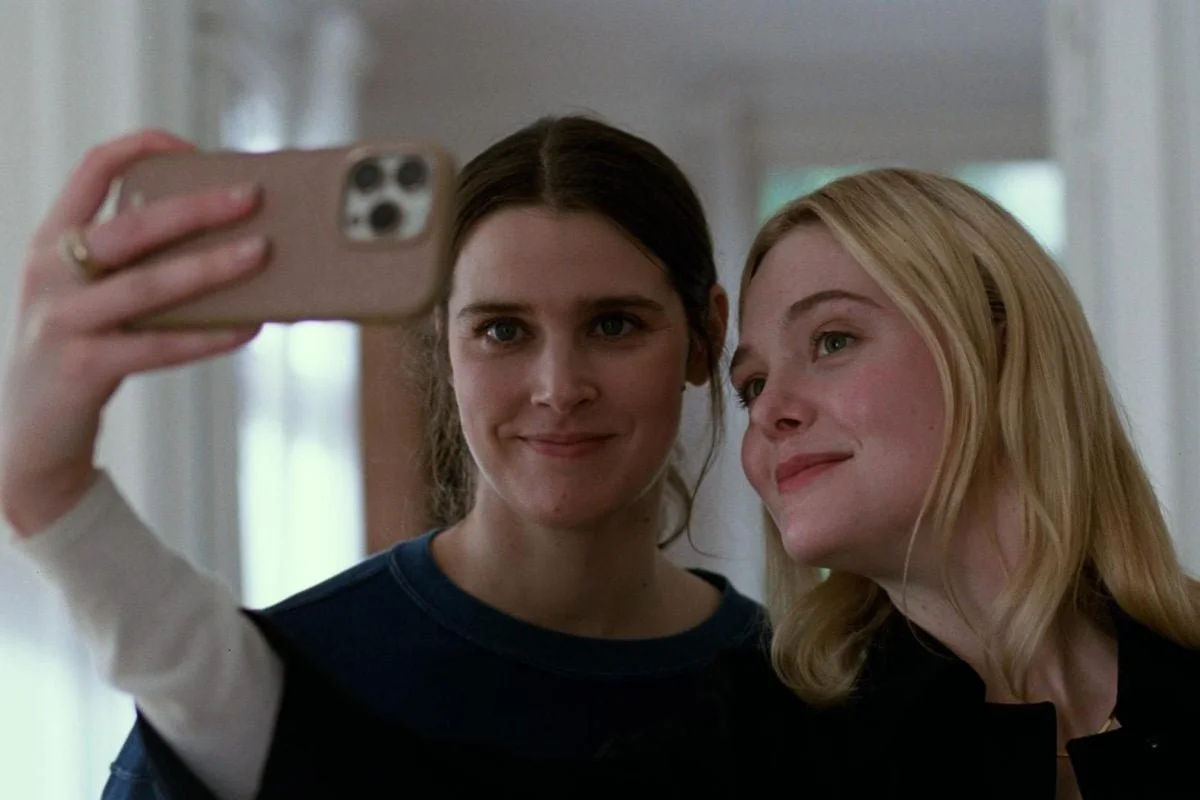 Three people looking intently at a computer screen. One person holds a phone. They appear focused and engaged.