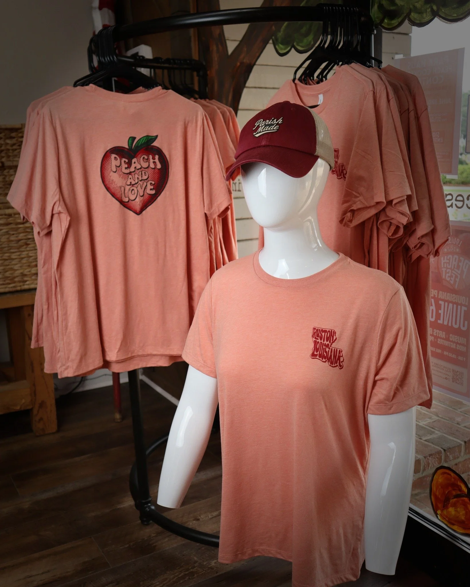 The 2026 Peach shirt design is officially here! 🍑

Show your love for Ruston red peaches with this women&rsquo;s cut softstyle tee. This is an in-store only limited run, so come grab yours before the rush Saturday. And remember, Peach and Love! ✌️