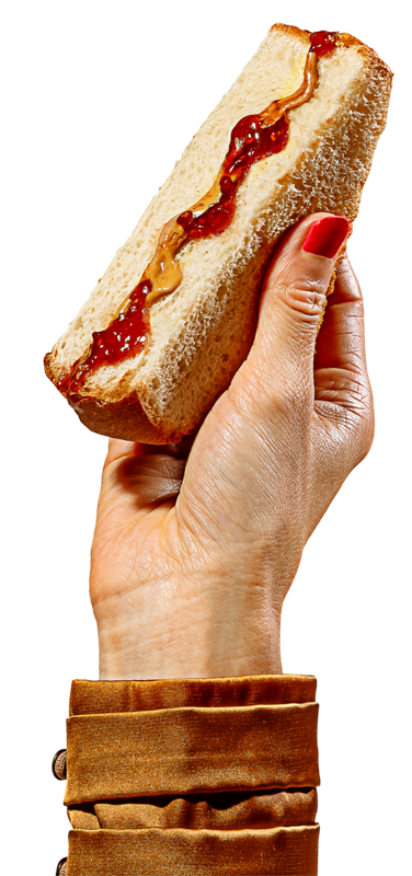 cutout of a hand holding up a delicious looking peanut butter and jelly sandwich