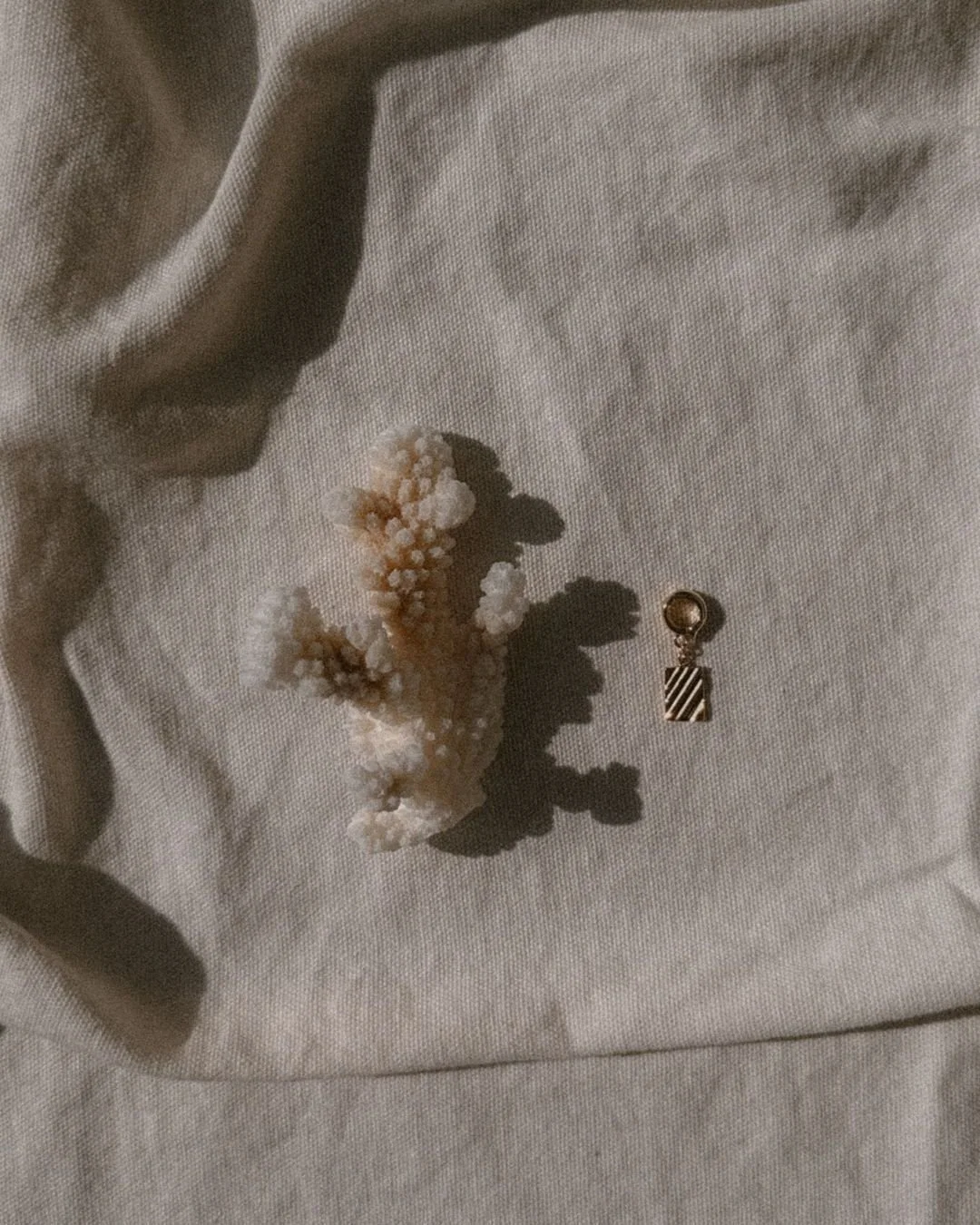 The prettiest secret you'll wear to the water. Our Chrysos Charm clasps right onto your string bikini strap, adding a delicate whisper of gold where you least expect it. It's the small details that make a story romantic. ✨ #earthtojuliet #smallbusine