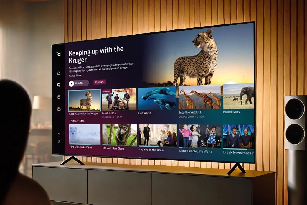 Figure watching TV displaying the Dplay homepage.