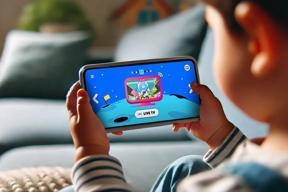 Young child holding a mobile phone navigating through the menu options of the Cartoon Network app