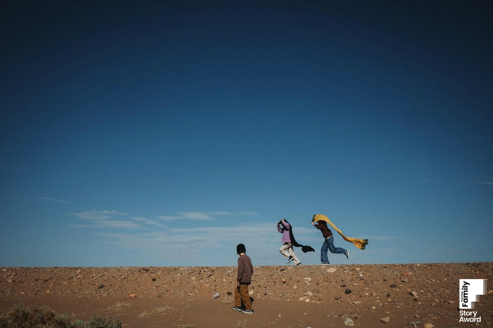 three kids playing in the Morocco desert