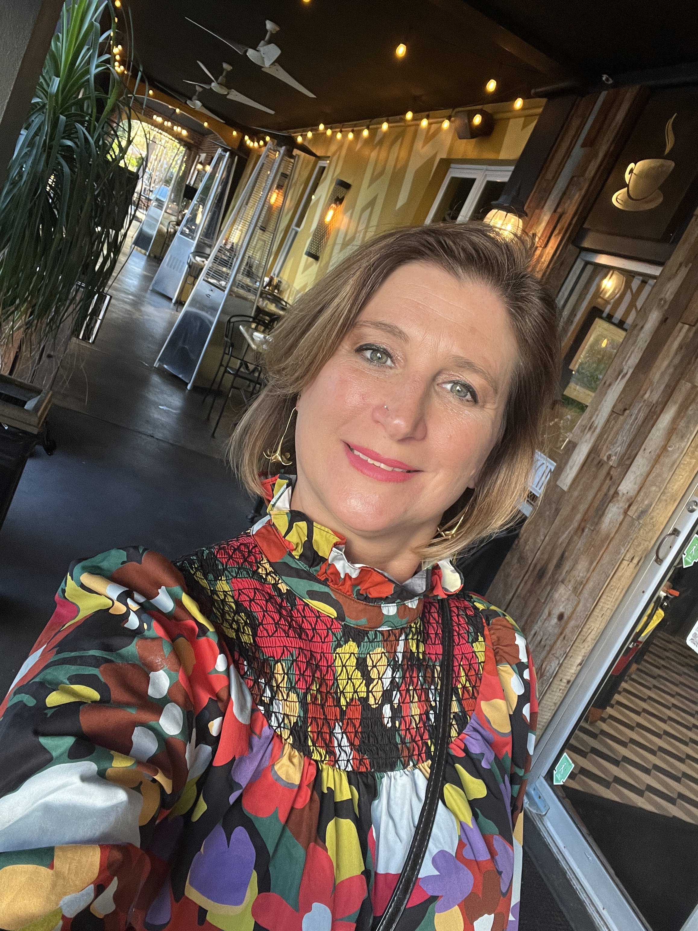 A woman wearing a floral pattern shirt