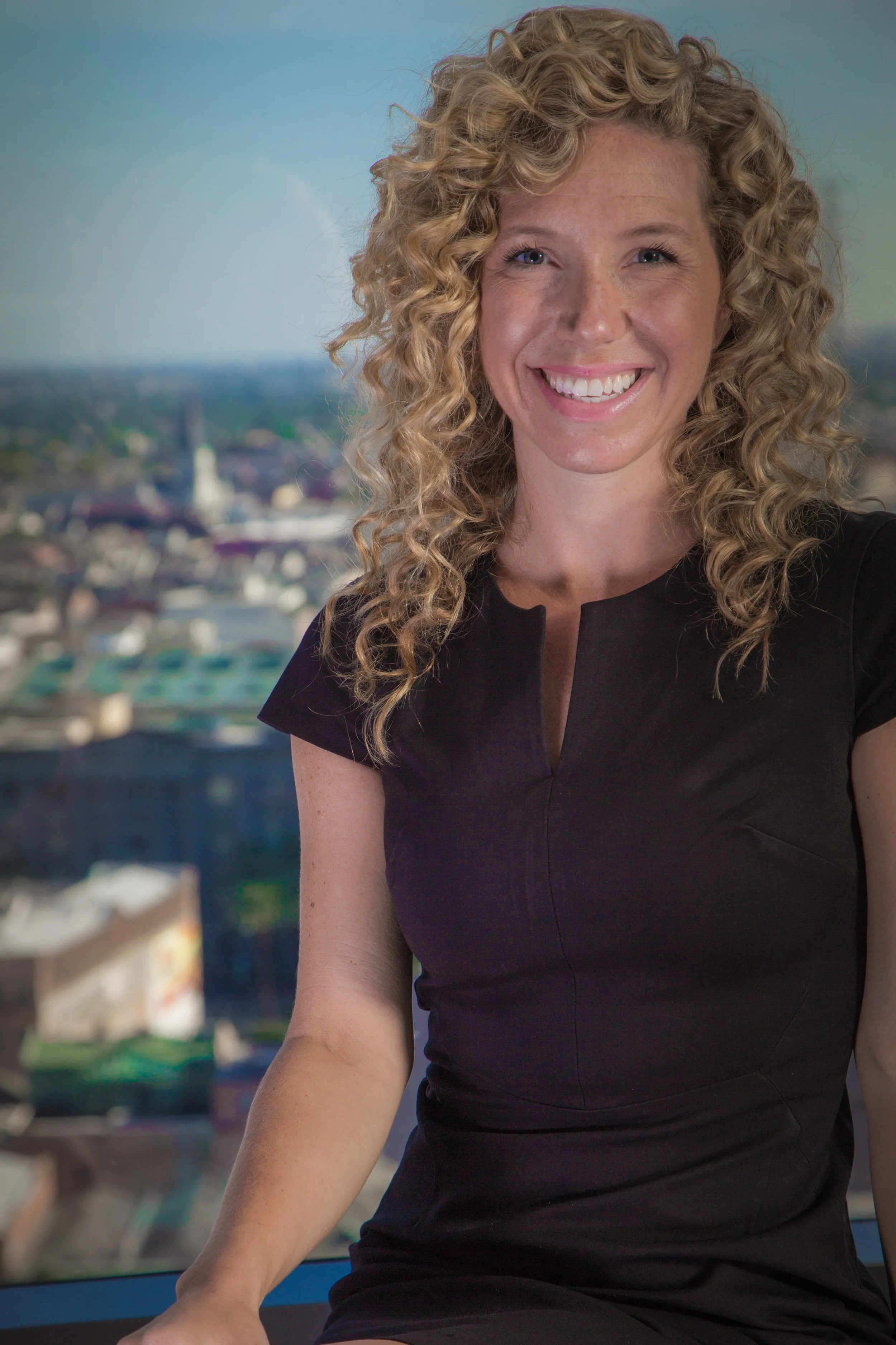 A woman wearing a black shirt and smiling