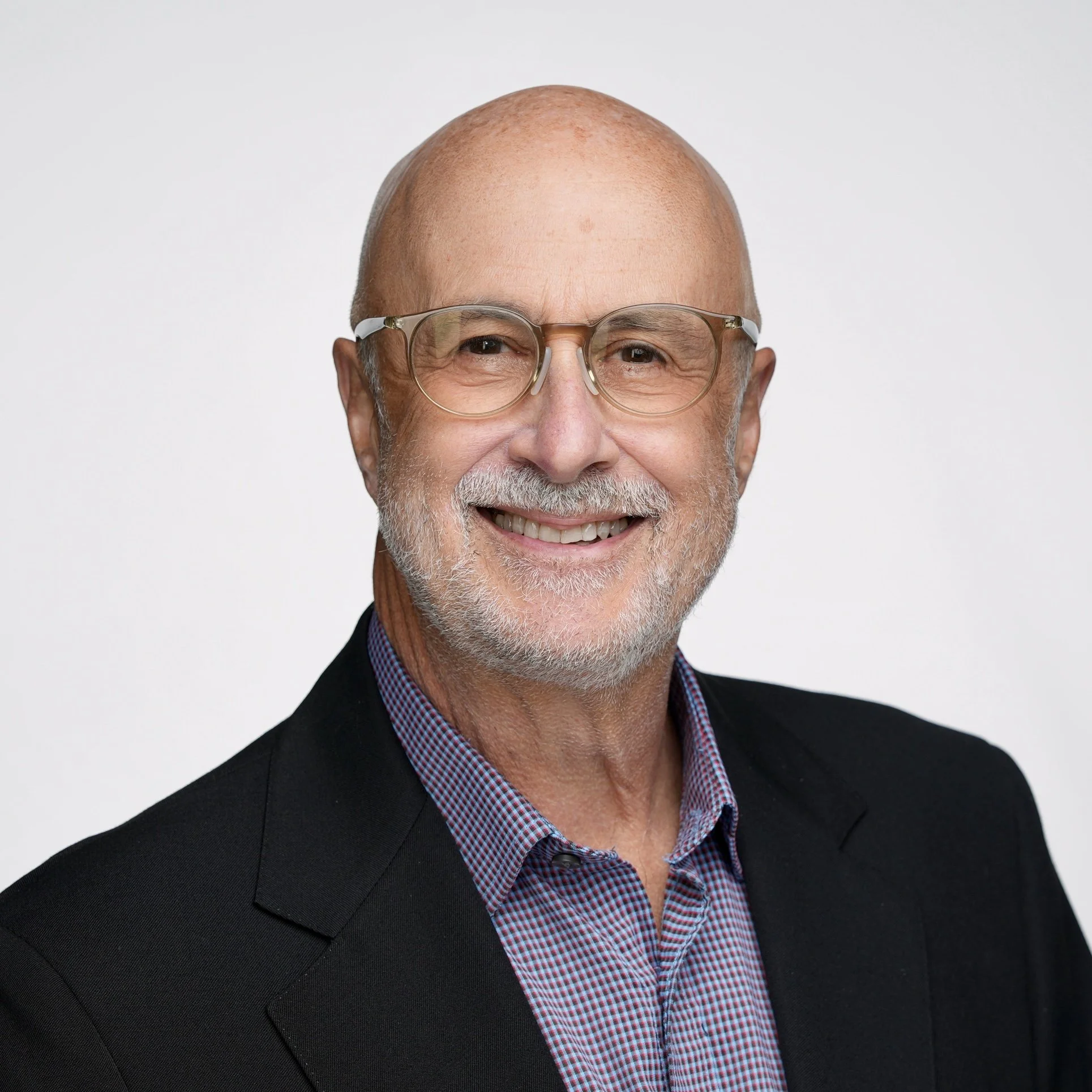 Man smiling with dark suit and no tie