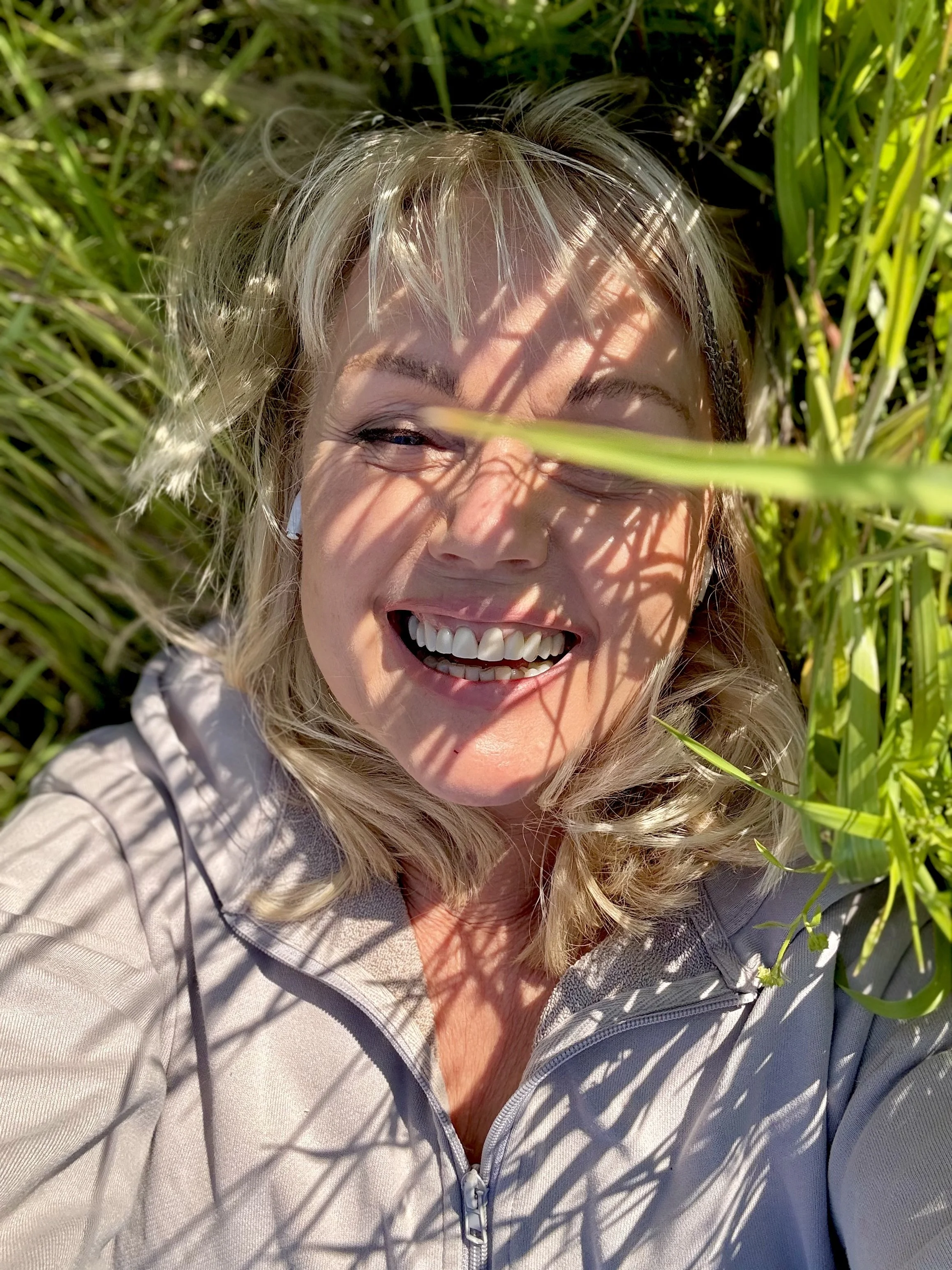 Annicken R. Day smiling among green plants.