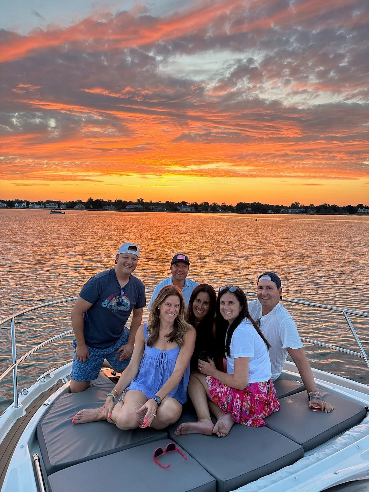 Guests enjoying the sunset on a private boat charter in Greenwich, Connecticut - Courtesy of Fairfield County Boat Charters