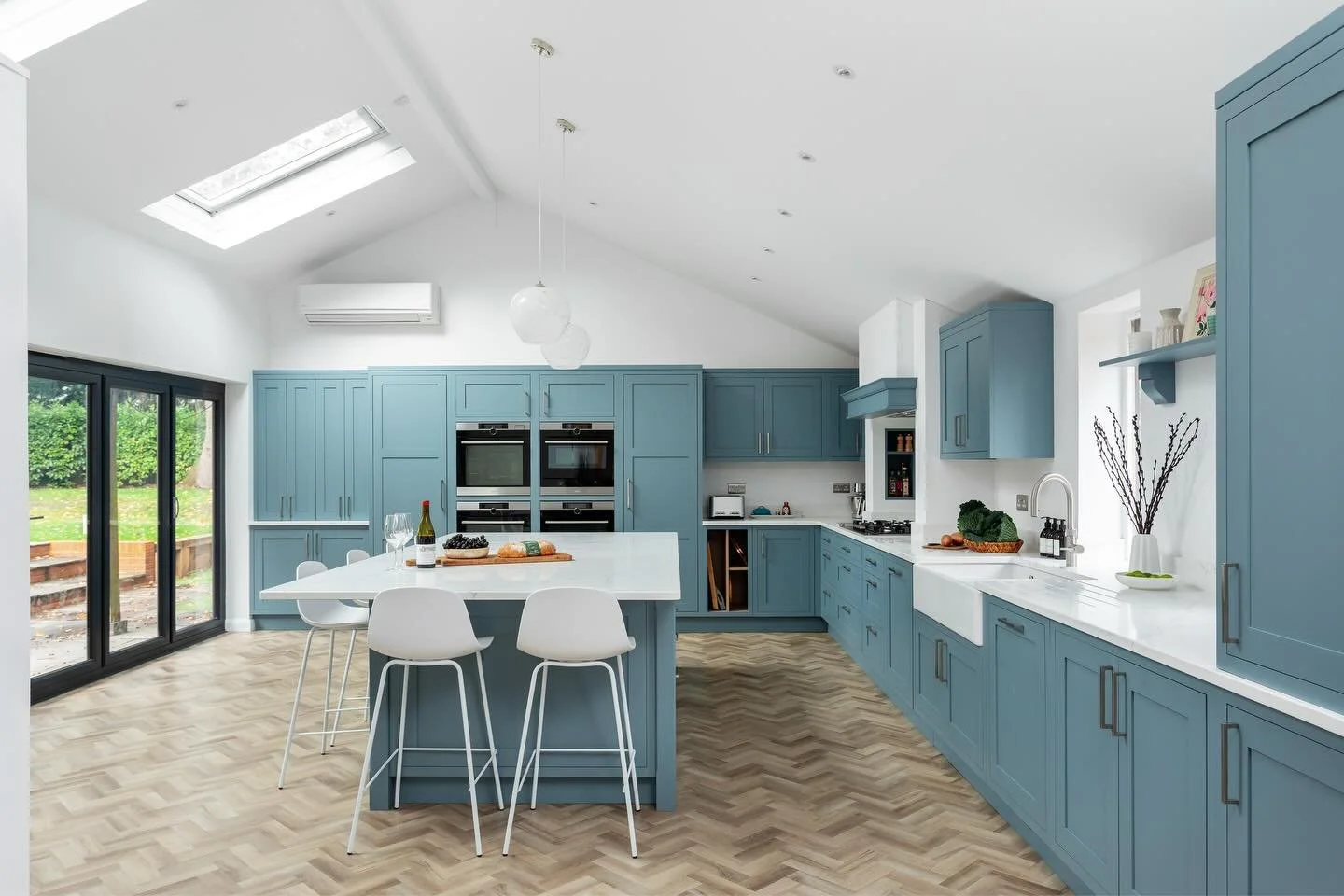 A full layout rethink transformed this space. The original kitchen was tucked into the smaller end of the room, while the vaulted area was being used as a lounge with an old brick fireplace. It didn&rsquo;t suit the family or make the most of the lig