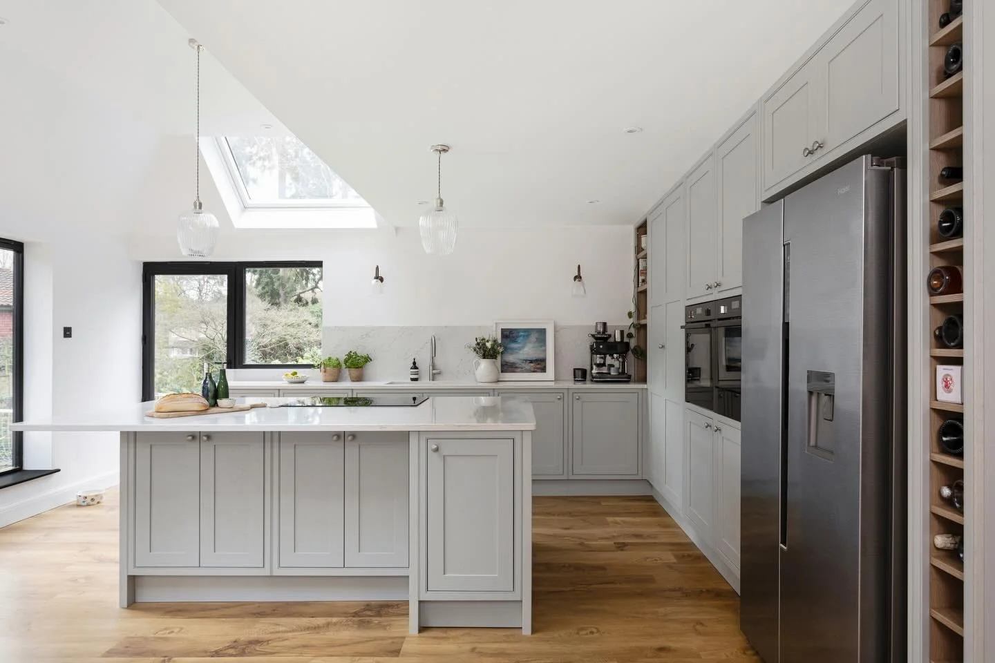 A calm, refined family kitchen designed for everyday living.

Our exclusive Newbridge in-frame shaker, painted in a colour matched Partridge Grey, paired with full height cabinetry for a clean, architectural feel.

A large island with Bora Pure vente