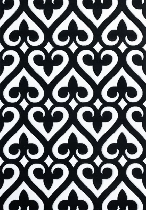 Black and white ornate repeating pattern with symmetrical floral and scroll elements.