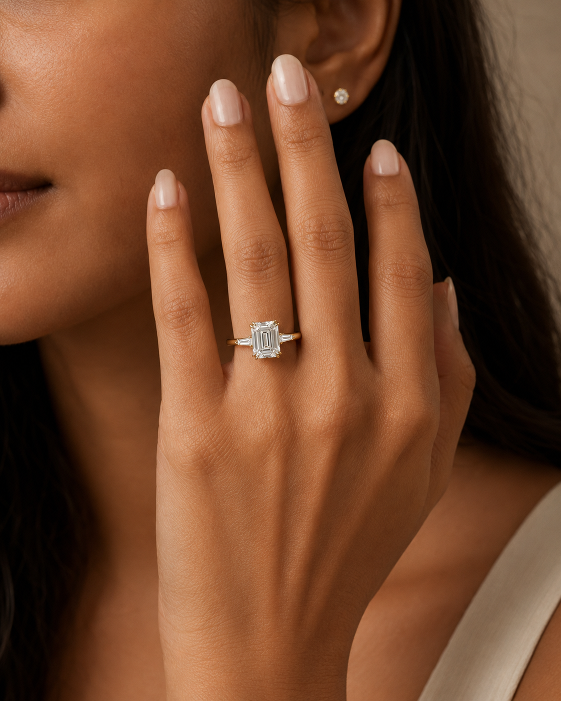 R03_Lifestyle_Yellow-Gold_Emerald-Three-Stone.png
