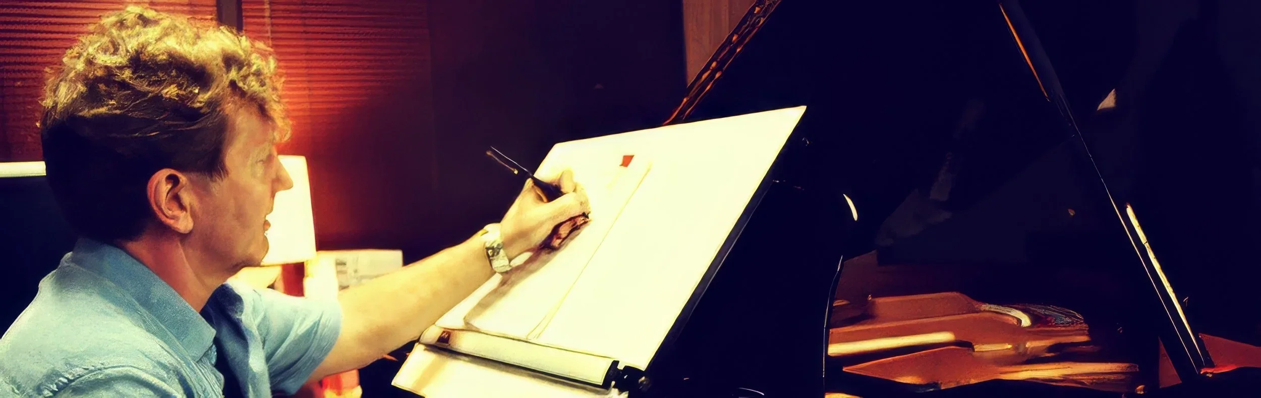 Hank Hehmsoth composing music at the grand piano in his studio, jazz composer and film score composer