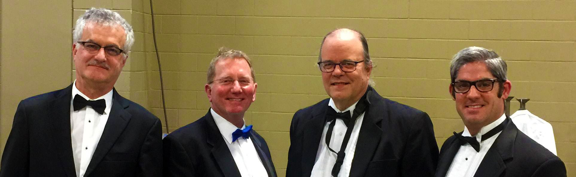 Members of John Mills Times Ten performing with the Austin Symphony Orchestra in tuxedos during pops concert