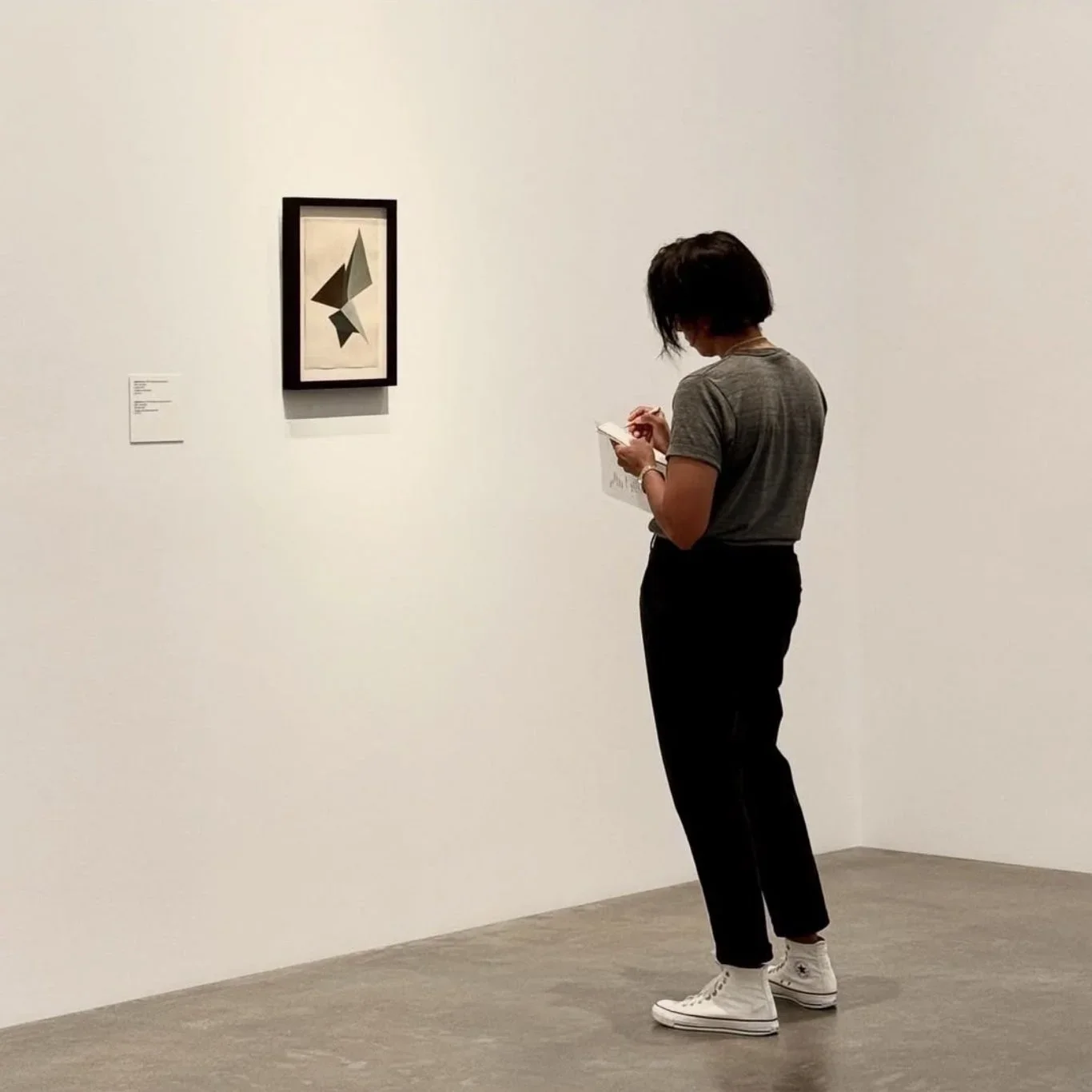 Workshop participant studying a painting during Seeing Sound Hearing Color at Brazosport College