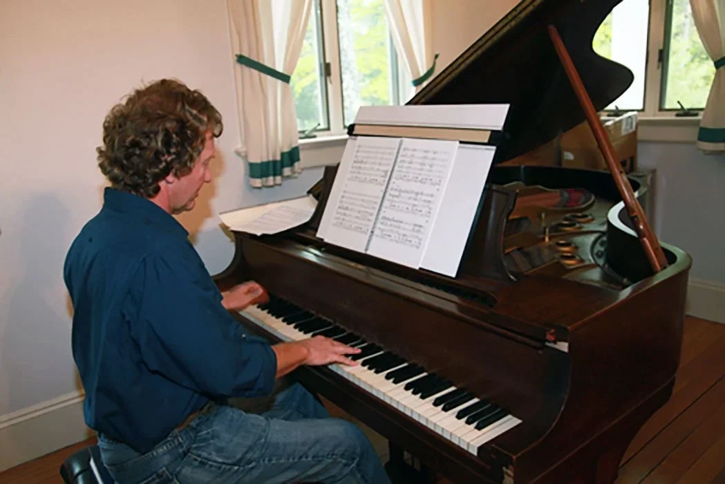 Hank Hehmsoth composing at piano in Watson Studio during MacDowell Colony artist residency
