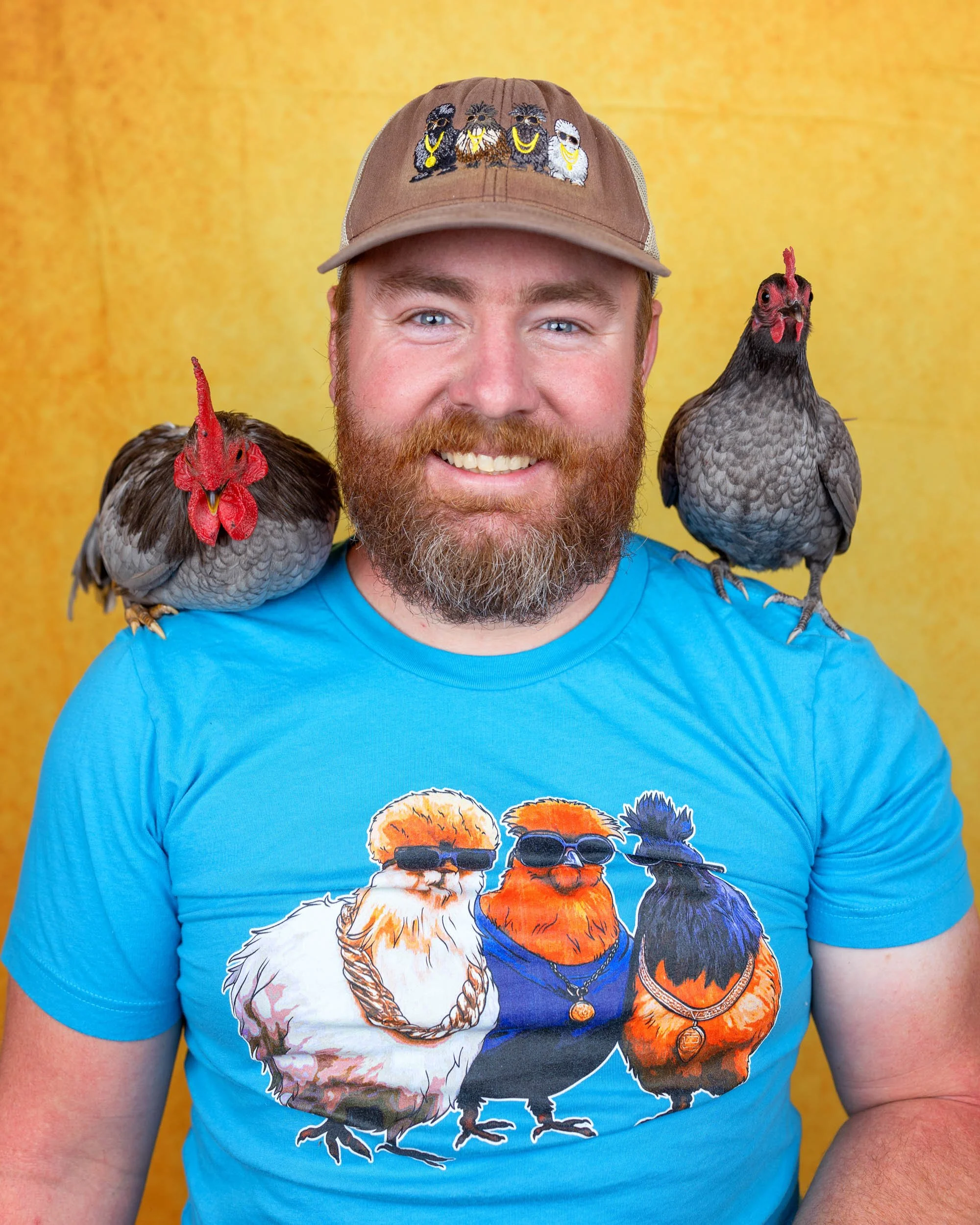 Portrait of Samuel Williams with two chickens on his shoulders