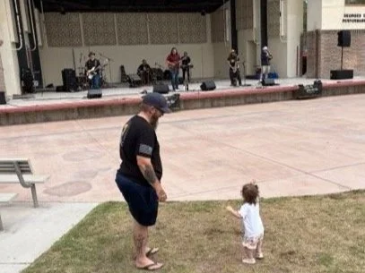 Todler dancing to the music with dad