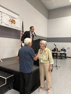 Janie Fisher winner of 50/50 raffle donates winnings to SACA