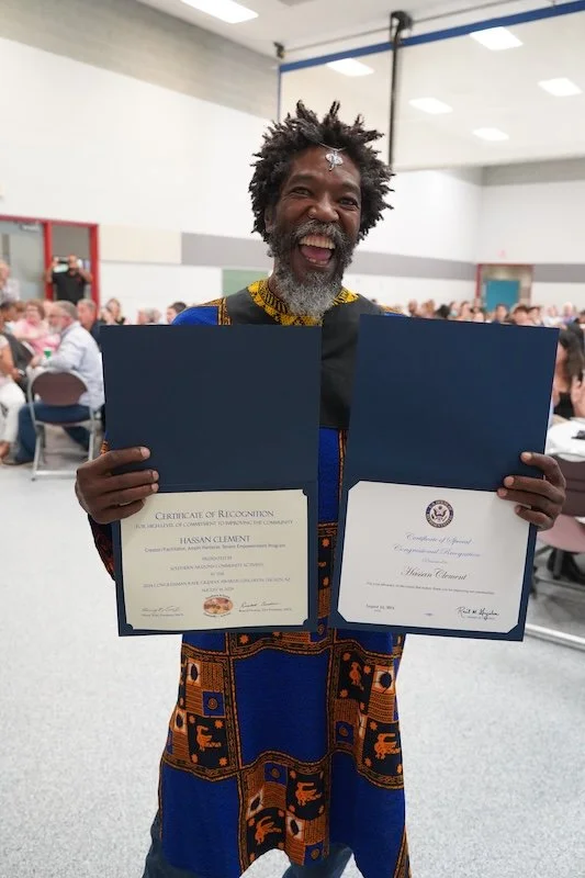 Hassan Clement showing awards.