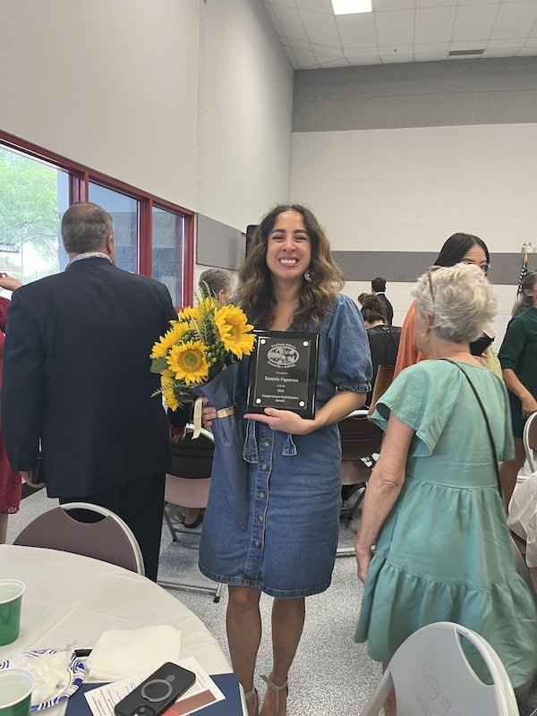 Daniela Figueroa receiving flowers from her co-workers