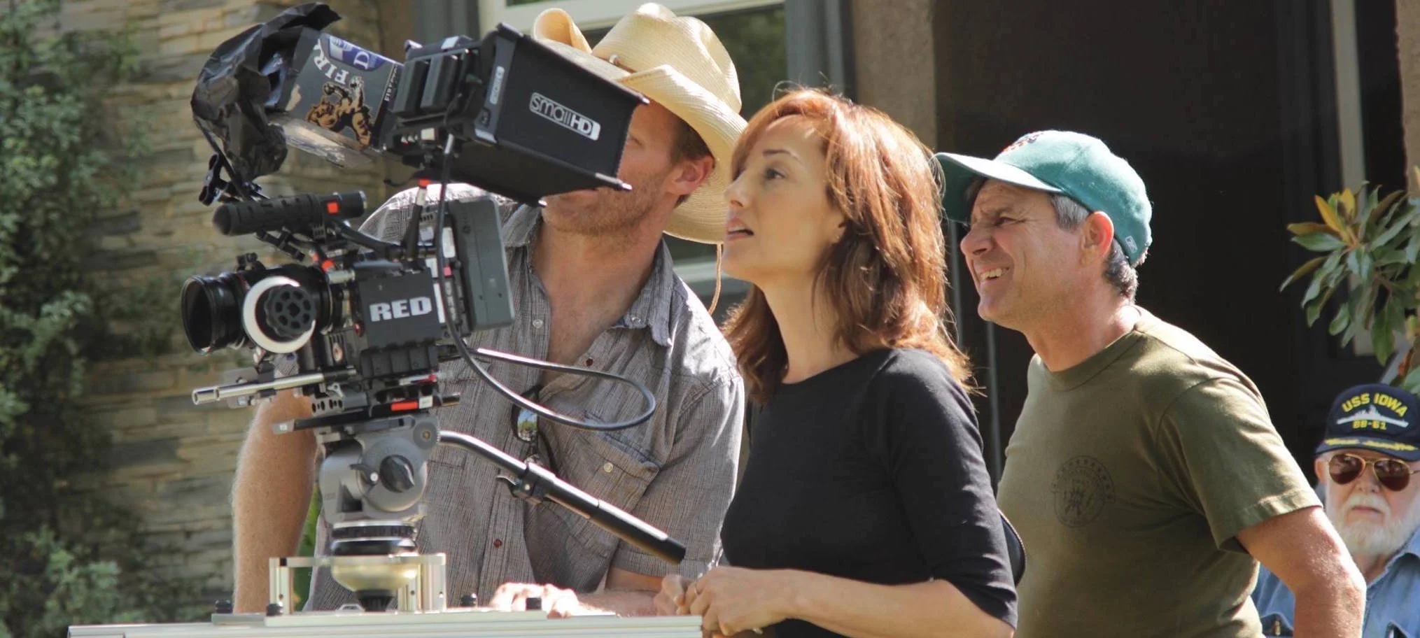 Filmmakers on set with camera equipment, director and crew.