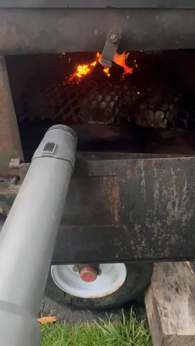 Pig Roast Bellows for the Fire.webp