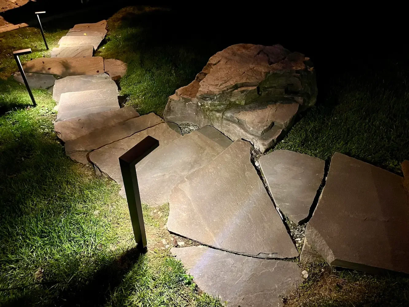 A well-lit pathway with custom outdoor lighting installed by Loudoun Lighting in Leesburg, Virginia, enhancing nighttime visibility and safety.
