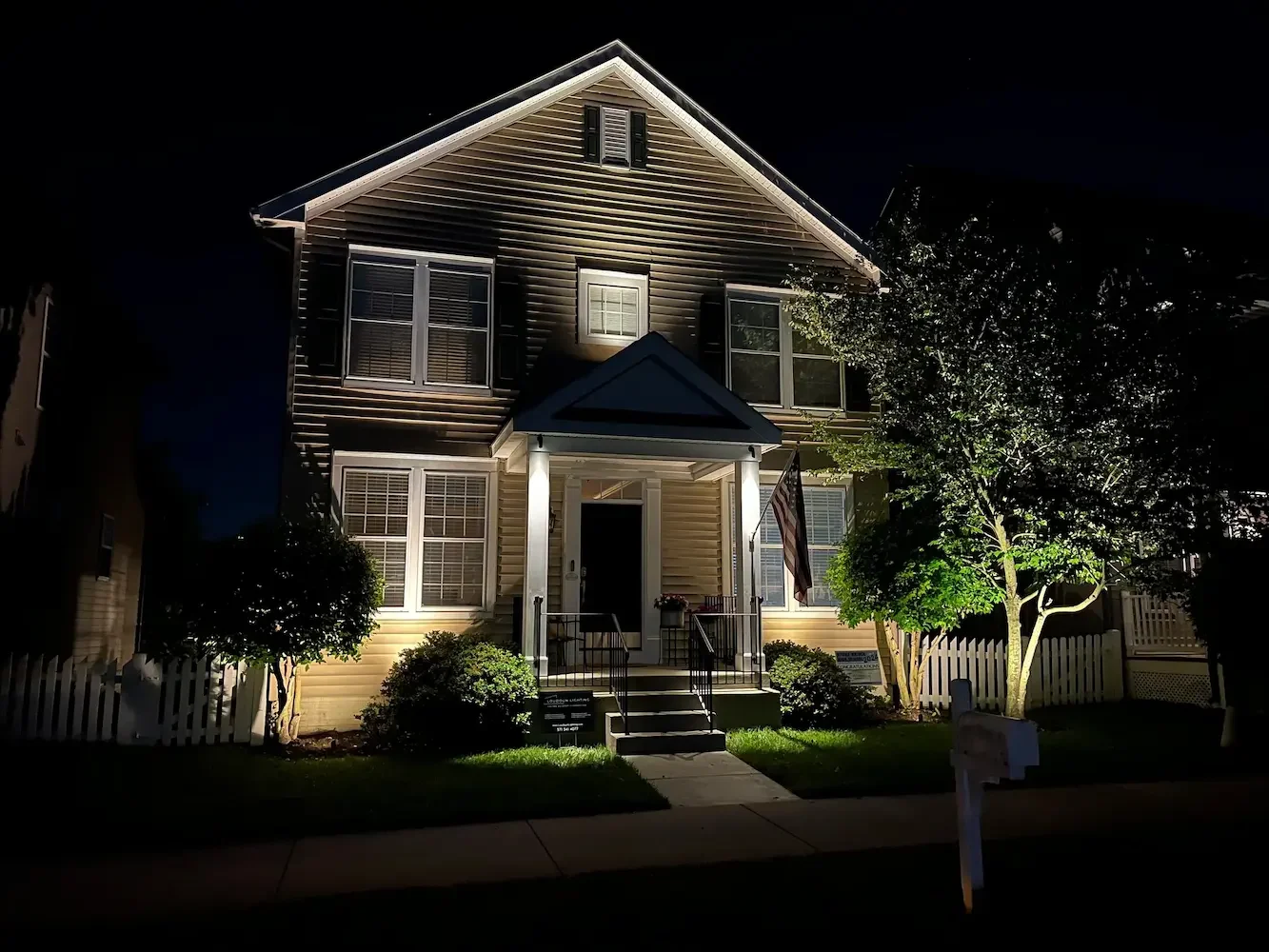 LED landscape lighting accentuating architectural features on a luxury home, installed by Loudoun Lighting for enhanced curb appeal in Northern Virginia.