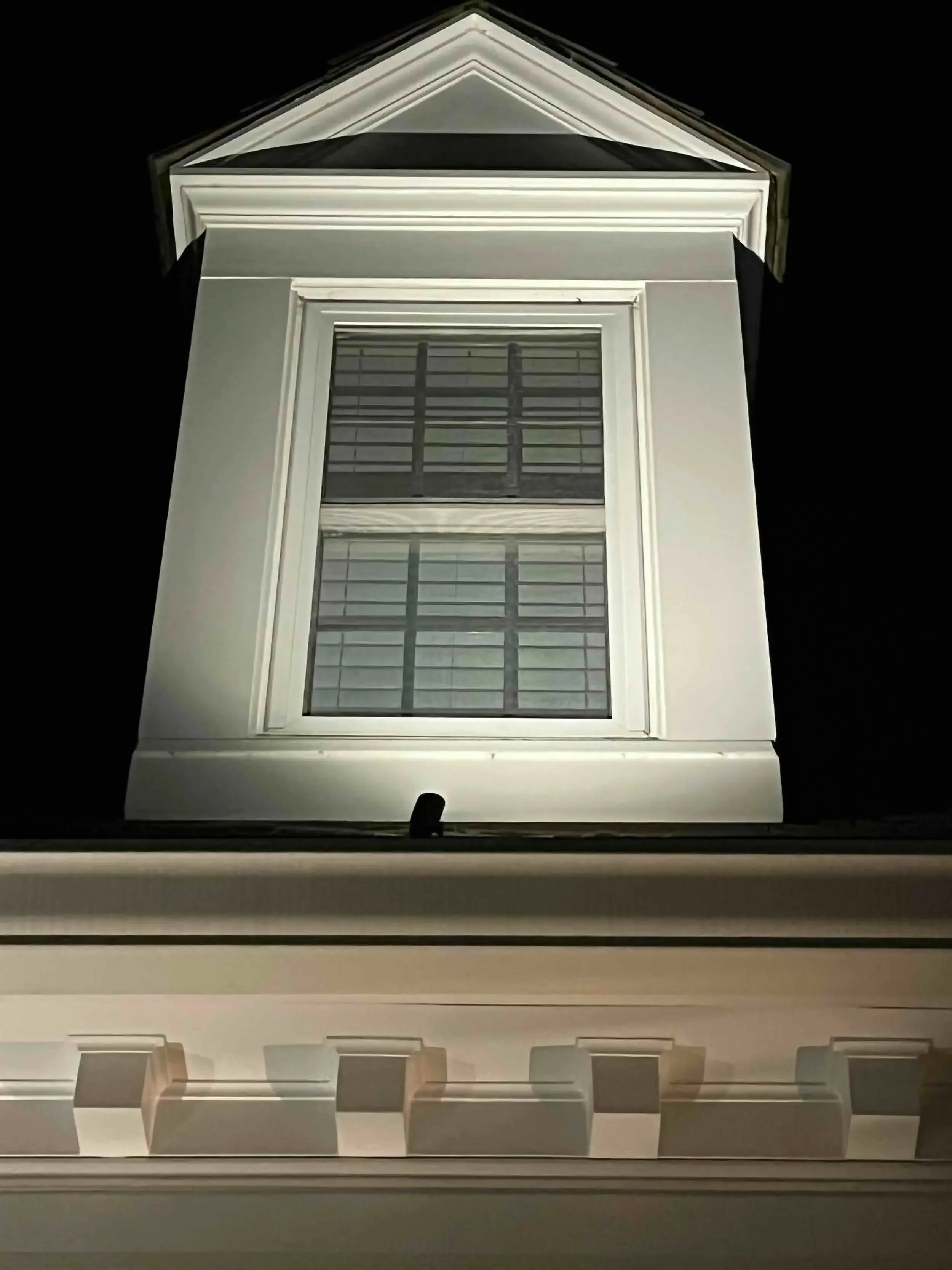 Gutter mounted fixtures enable upper-story dormers to "pop". Highlighting architectural details adds sophistication to this home’s facade.