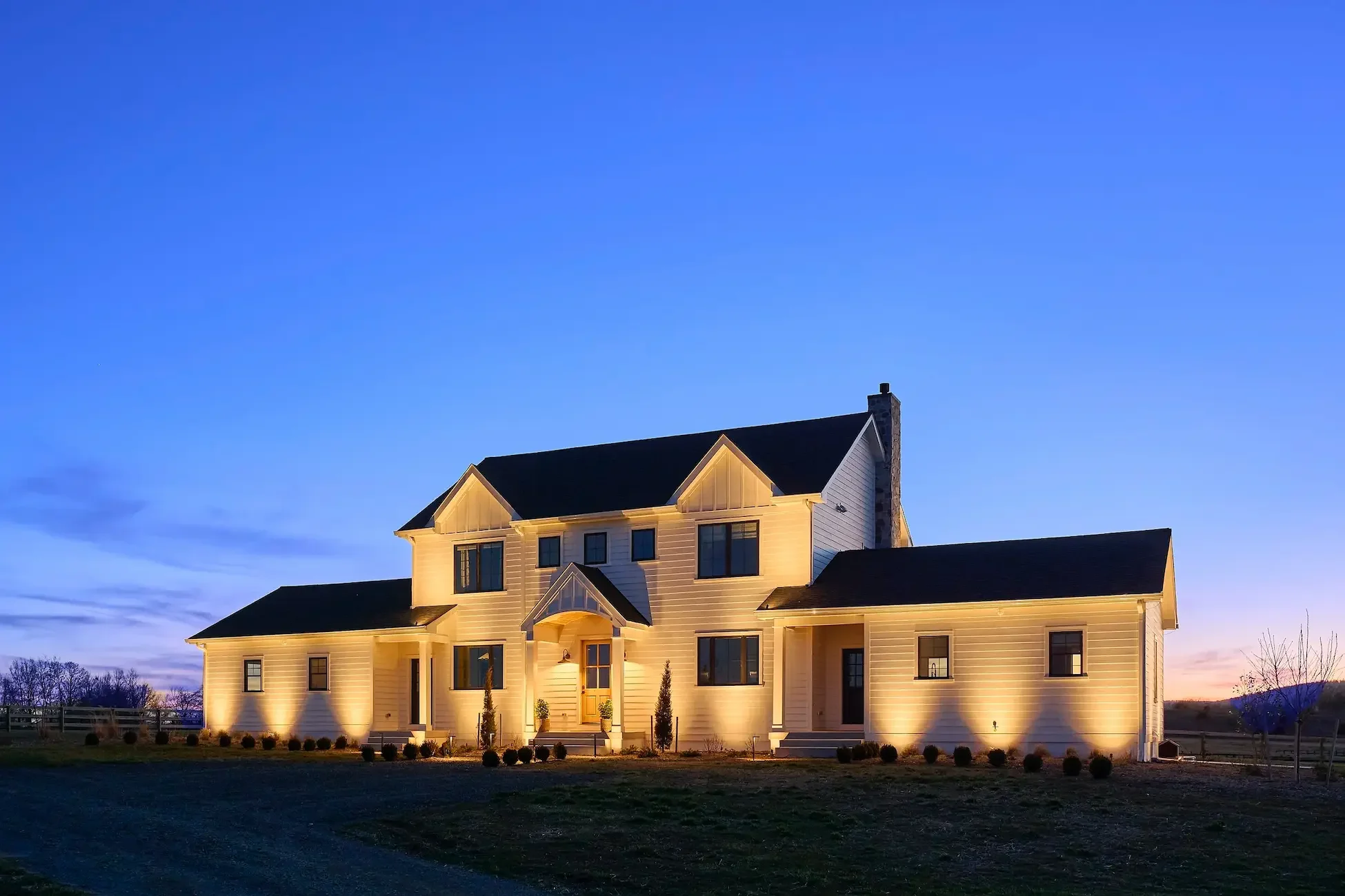 Modern farmhouse at dusk – Lighting by Loudoun Lighting LLC, design by Cawood Architecture PLLC, construction by Alair Homes Hunt Country, and photography by Peggy Cormary of Peggy Cormary Photography LLC.