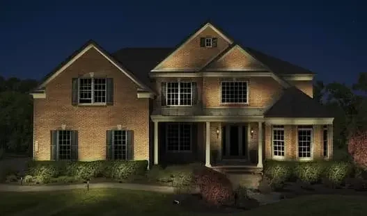 Photo Rendering of a large brick house illuminated at night with Loudoun Lighting.