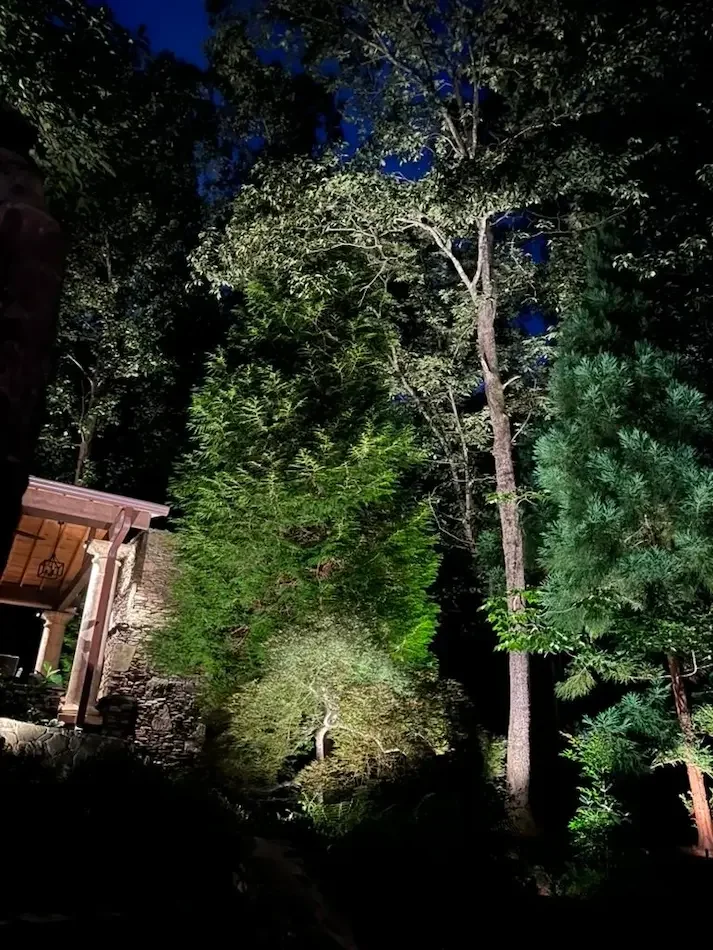 Landscape lighting creates depth, scale, and long-distance visibility.