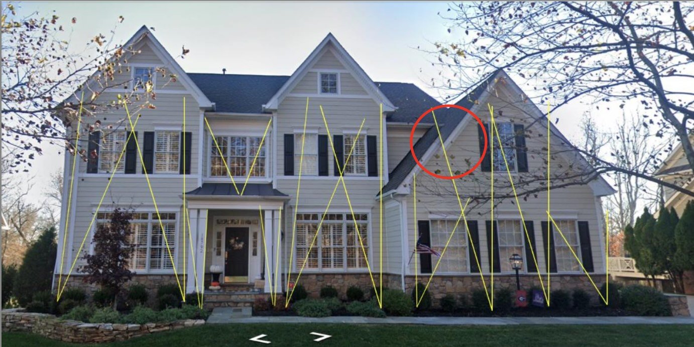White two-story house with black shutters and green lawn, featuring yellow lines and a red circle highlighting architectural details.