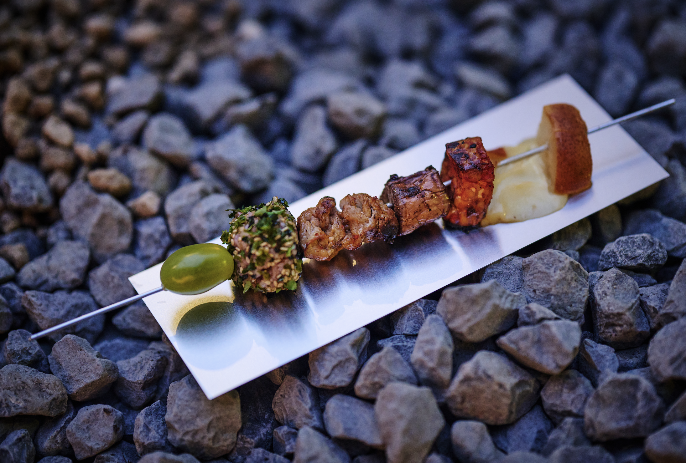 'Planetary Diet' skewer of the future, tomato gochujang tempeh, sweet eggplant, grilled pear, scarmoza, climate-future grain ball, pork belly, green tomato // Humboldt residency Out of the Rubble dinner (staged by Lily Consuelo Saporta Taguiri, image