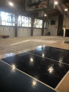 Large scale floor demolition performed on a gymnasium by DMI.