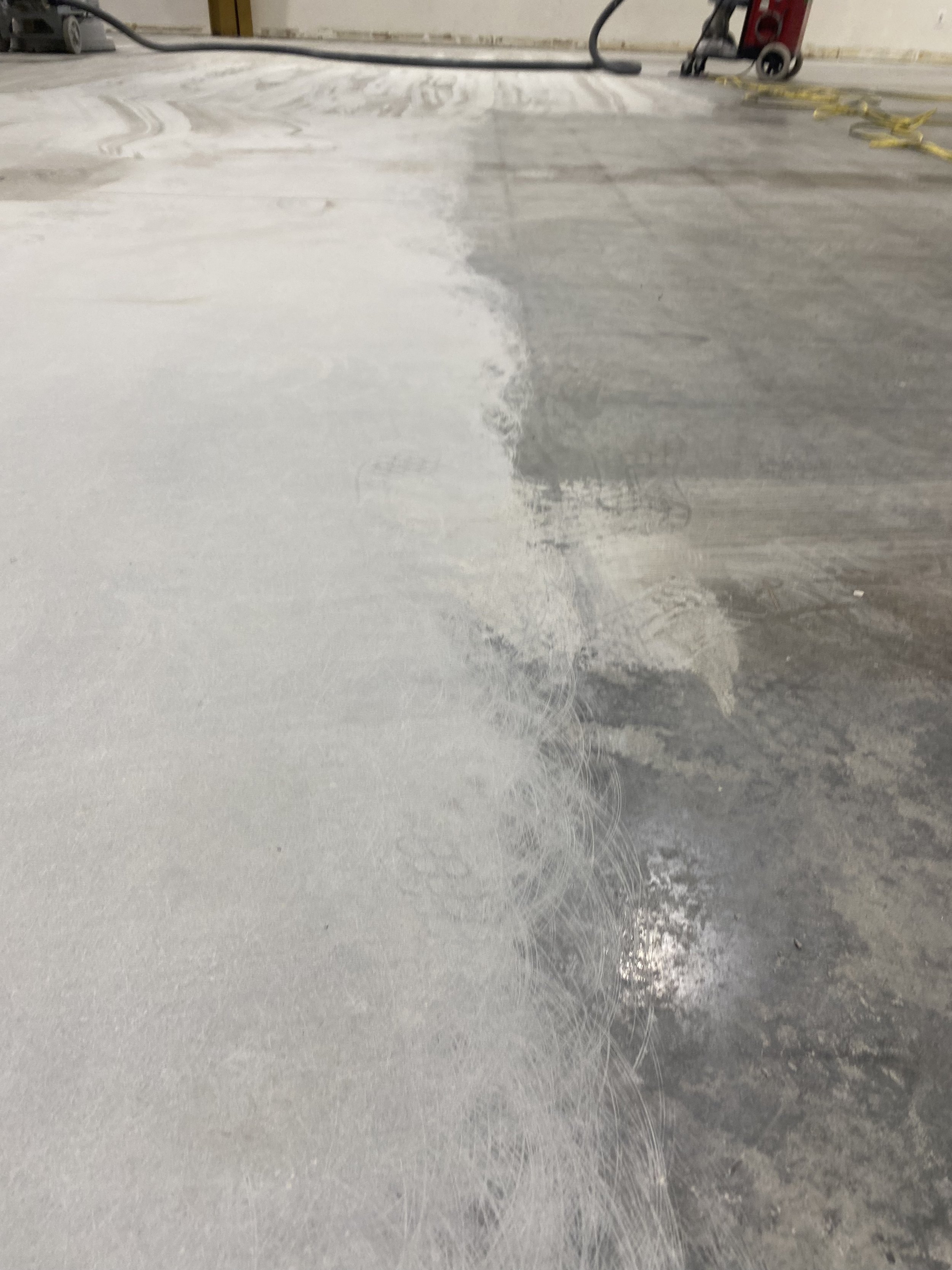 Concrete on a local gymnasium being prepped and grinded by DMI techs