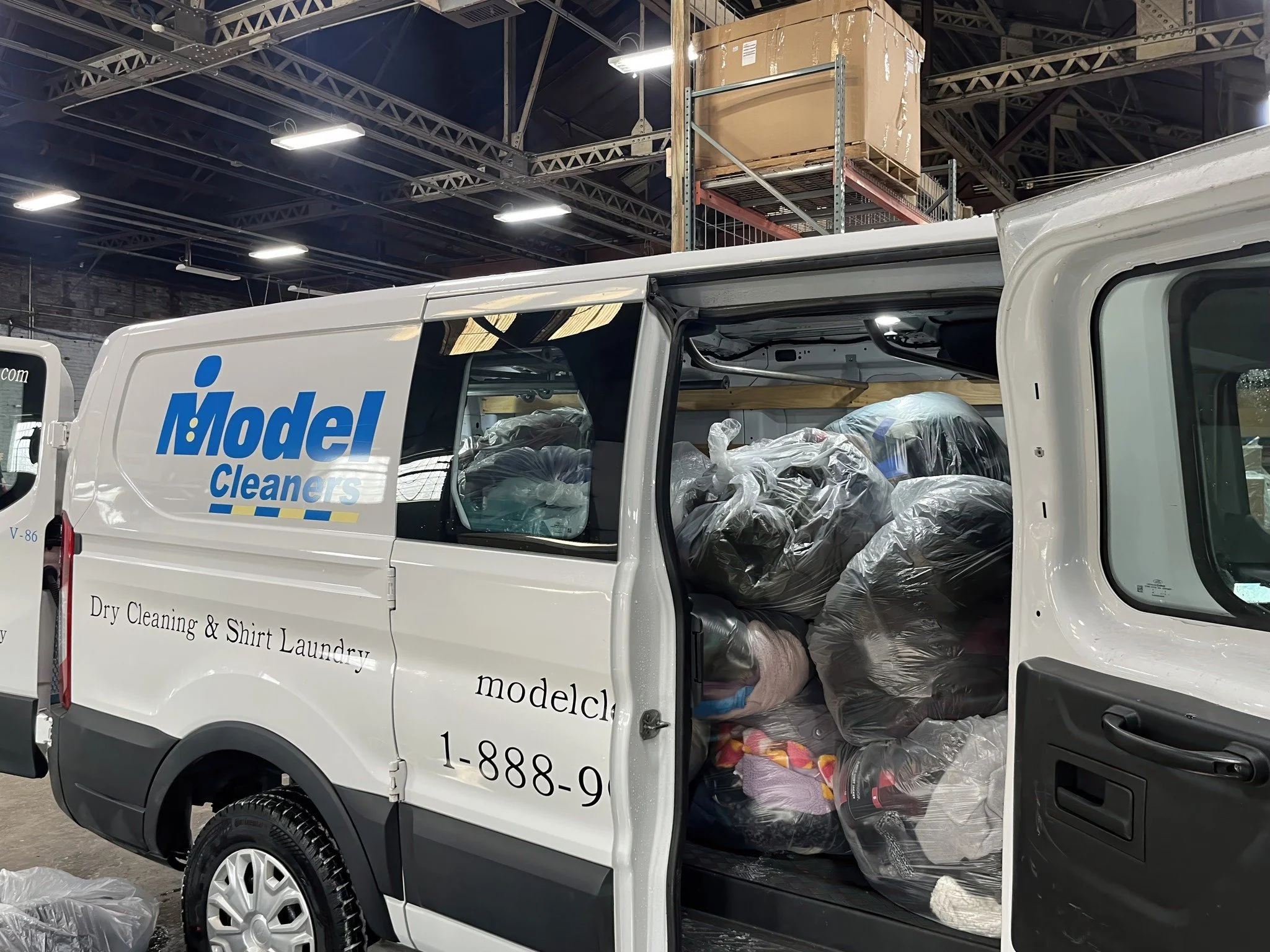 Model Cleaners delivery van loaded with laundry bags for pickup and delivery dry cleaning service across Pittsburgh and Western Pennsylvania