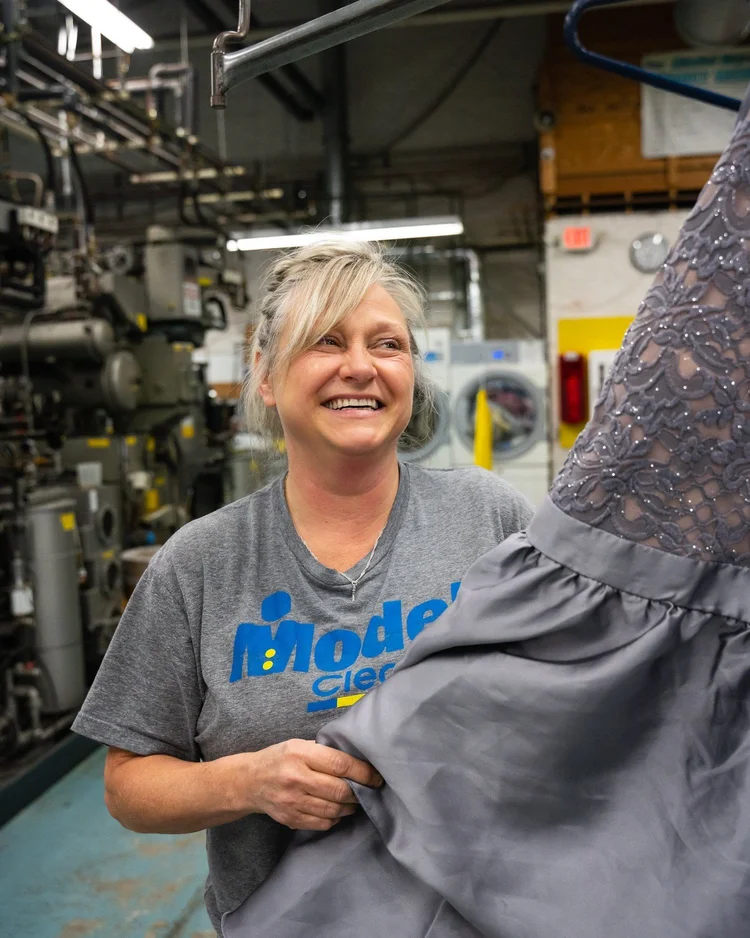 Model Cleaners employee handling a garment at the Pittsburgh dry cleaning facility