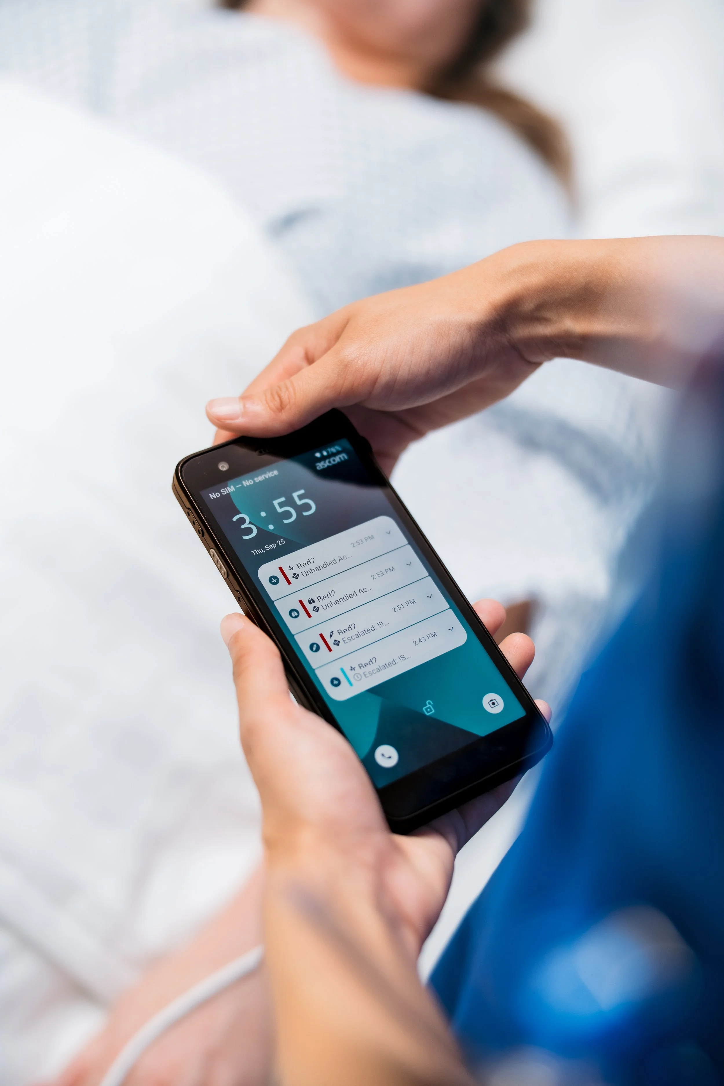 Person holding a smartphone with a call log screen visible, while another person appears to be reaching to the phone in the background.