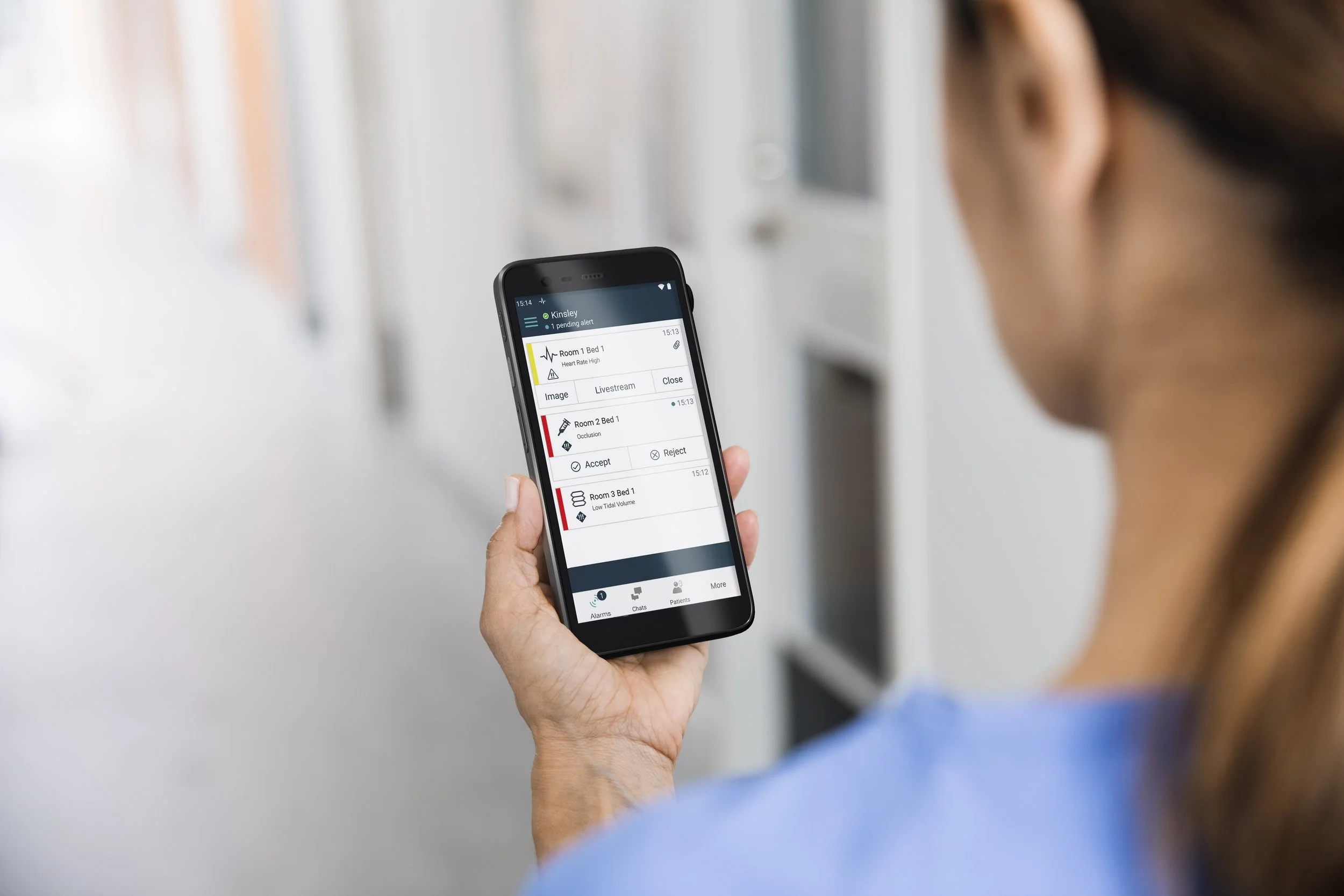 Nurse holding Myco 4 smartphone alerting
