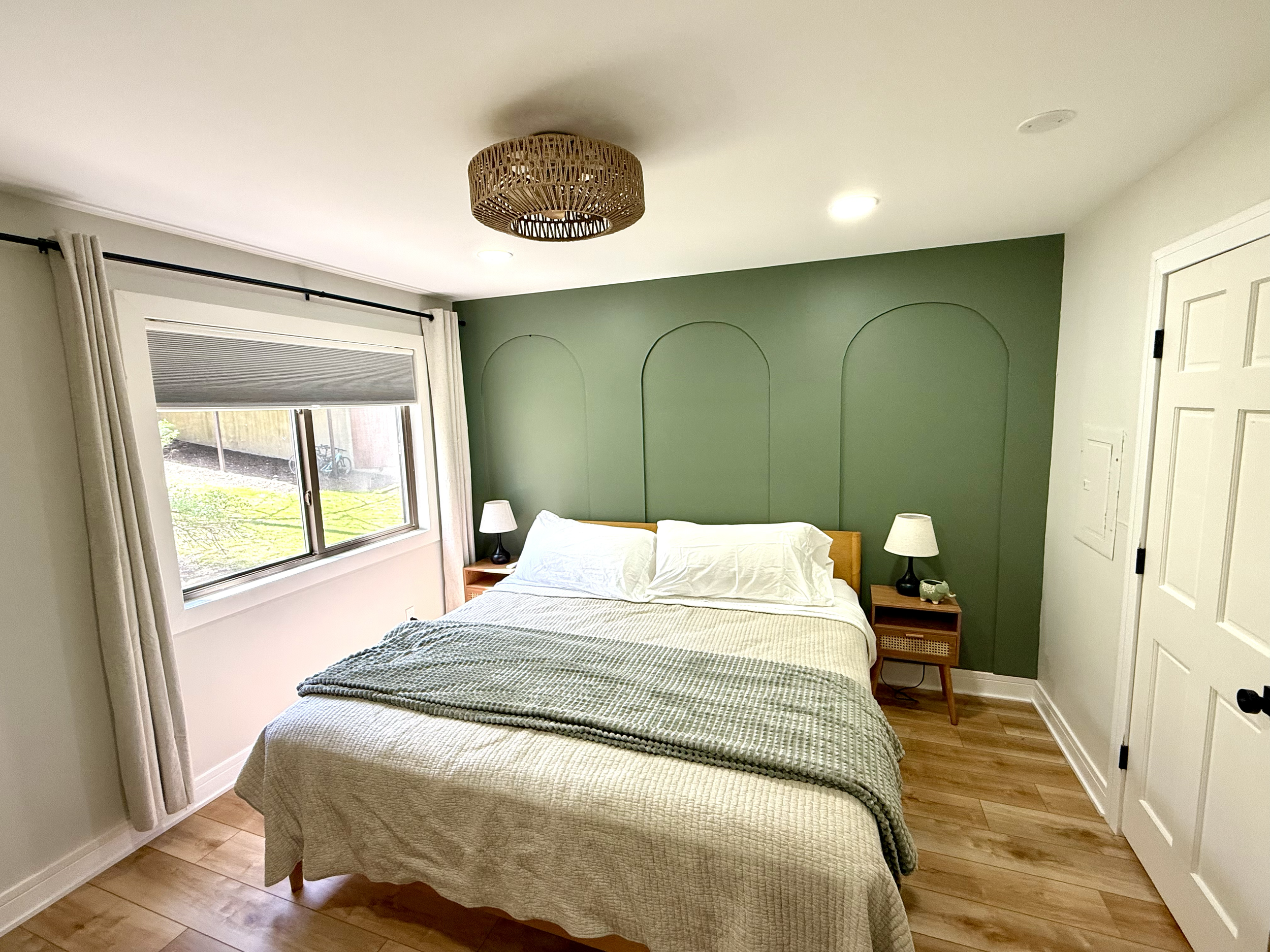 Upstairs master bedroom with king bed adjacent to bathroom