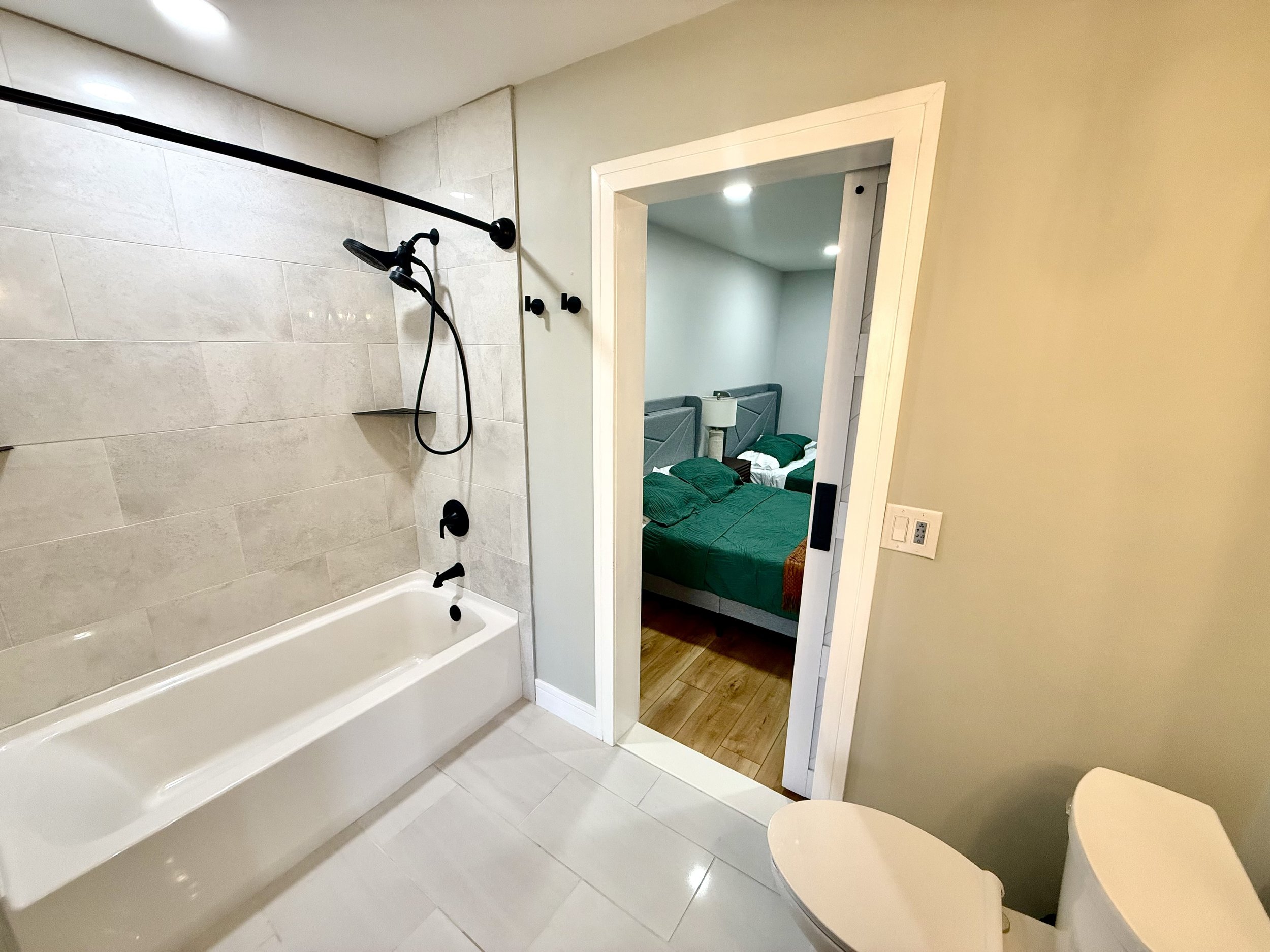 Downstairs bedroom includes relaxing bath and shower