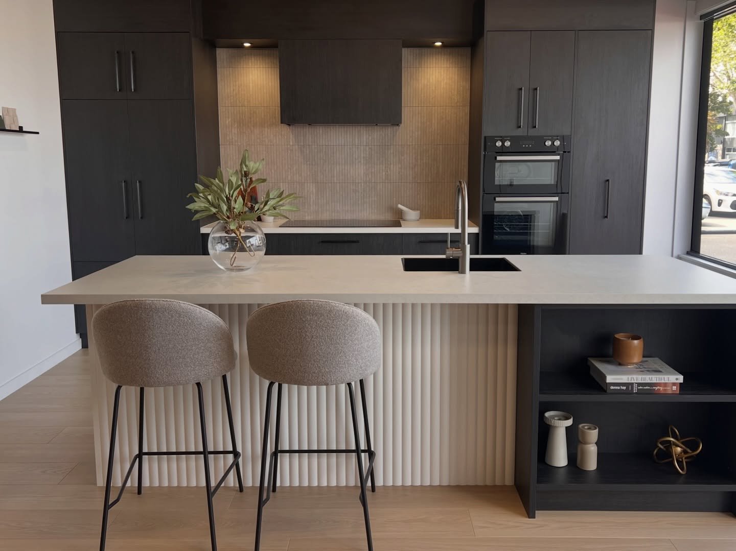 This kitchen was all about balancing contrast and calm, dark @laminexnz Melteca Blackened Ash cabinetry, a lighter sculptural island using Laminex Surround Demi Round painted in Resene Double Alabaster and details that feel considered without being o