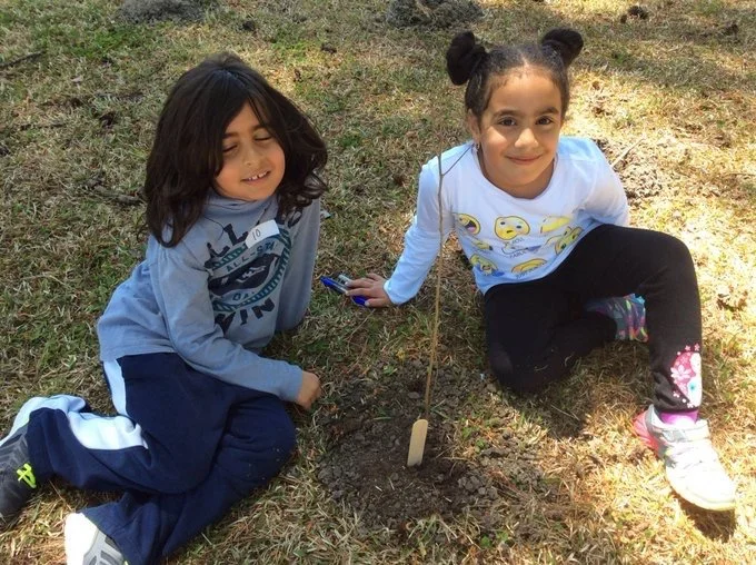 Students pose with their sapling