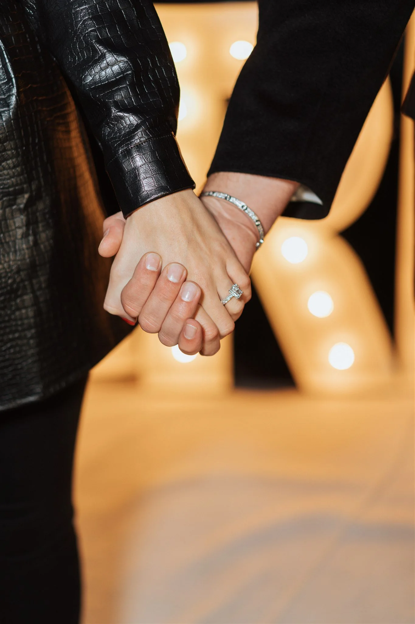 hands being held after proposal showing engagement ring