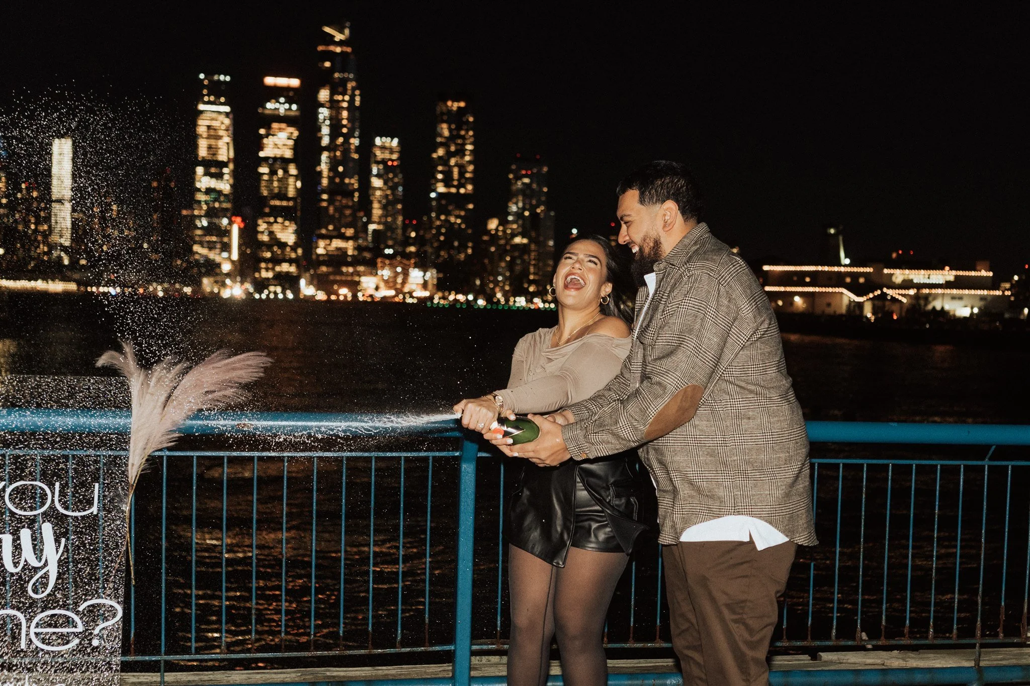 Couple popping champagne after proposal