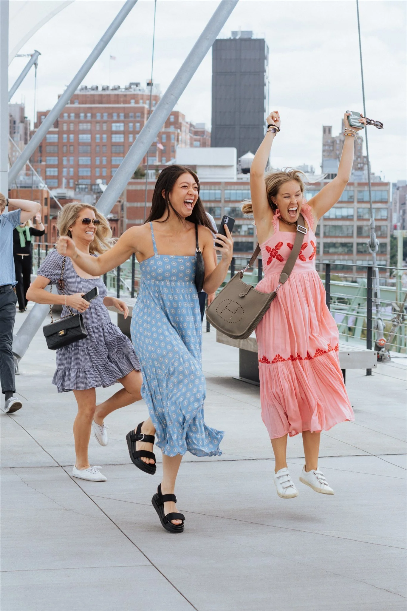 friends jumping for joy after nyc proposal