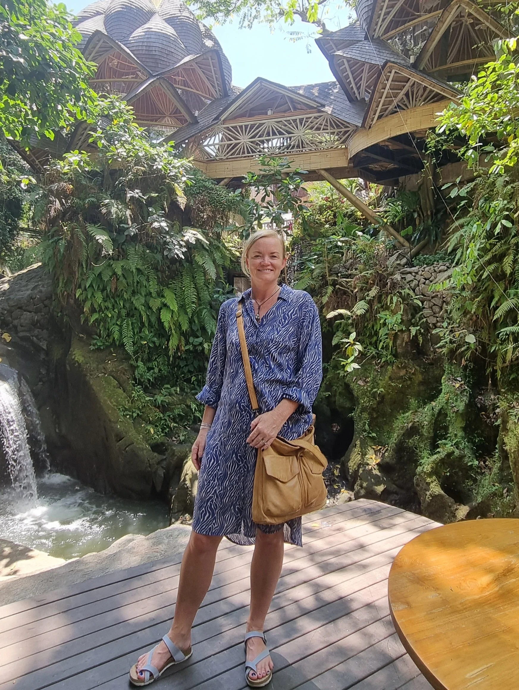 sally standing on a wooden platform amongst trees